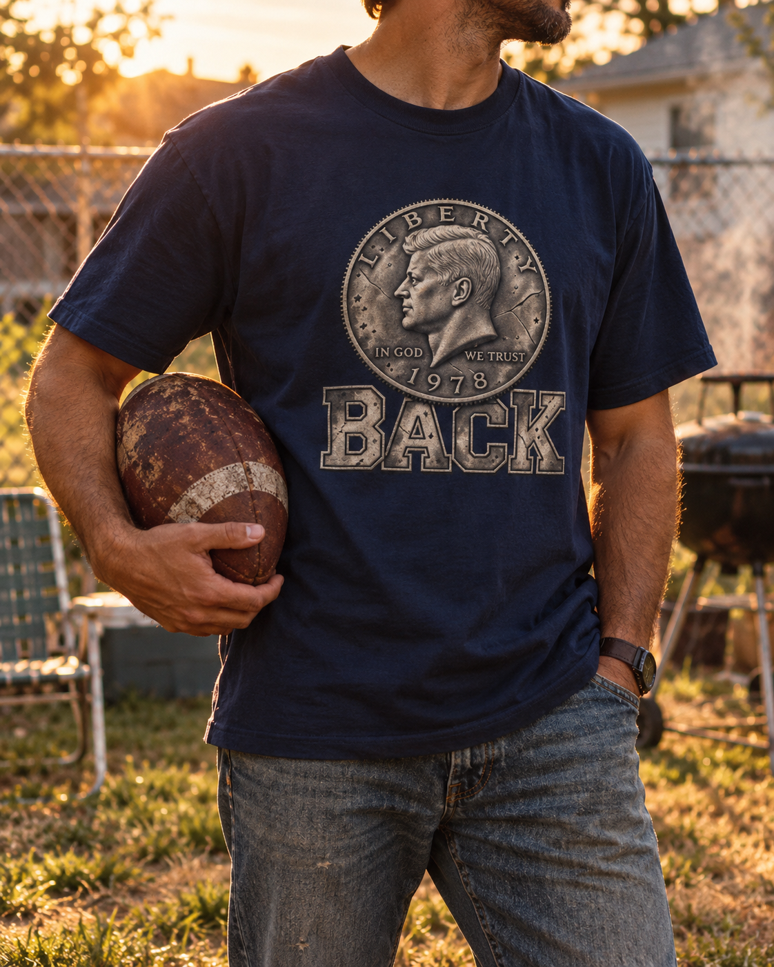 Man in a backyard at golden hour wearing the navy Half Back tee — 1978 half dollar above BACK, YARD RULES